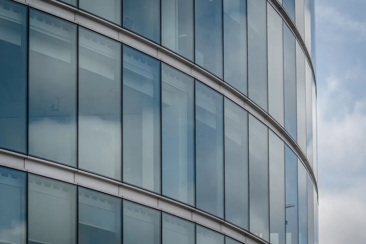 The curved glass facade of an office building in London
